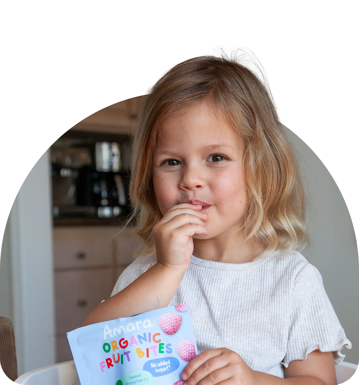 baby girl holding amara fruitbites pack